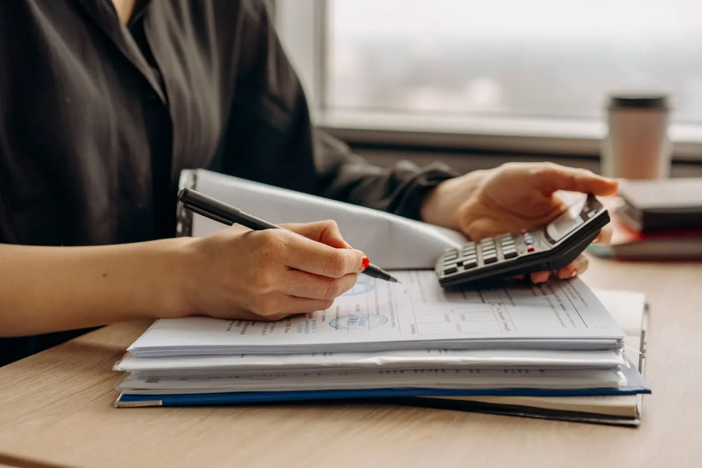 Mortgage paperwork and calculator on desk